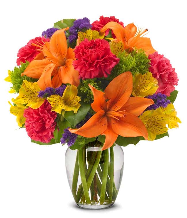 Orange lilies, Yellow alstroemeria, and hot pink carnations delivered by florist in orange vase