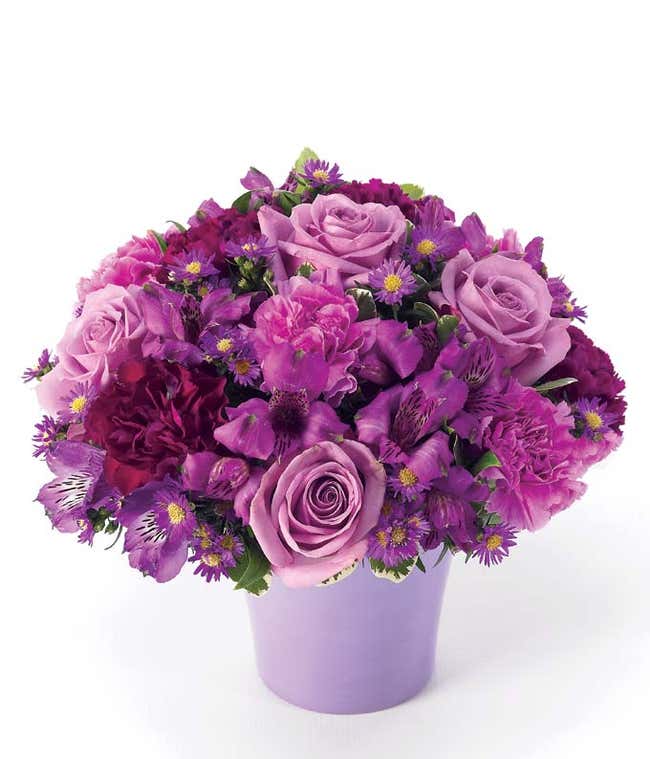 Purple roses, purple alstroemeria and lavender carnations in vase