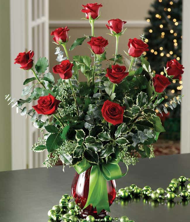 One dozen red roses with holly for Christmas