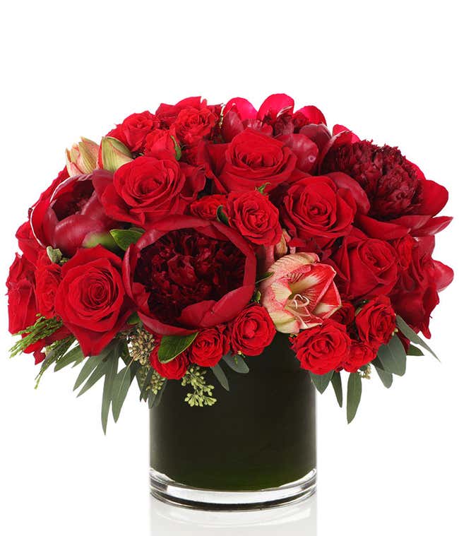 Red roses and Amaryllis in a cylinder glass vase 