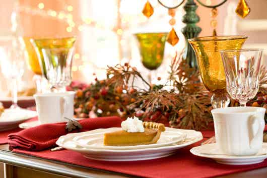 Thanksgiving Table with Slided of Pumpkin Pie on Plate